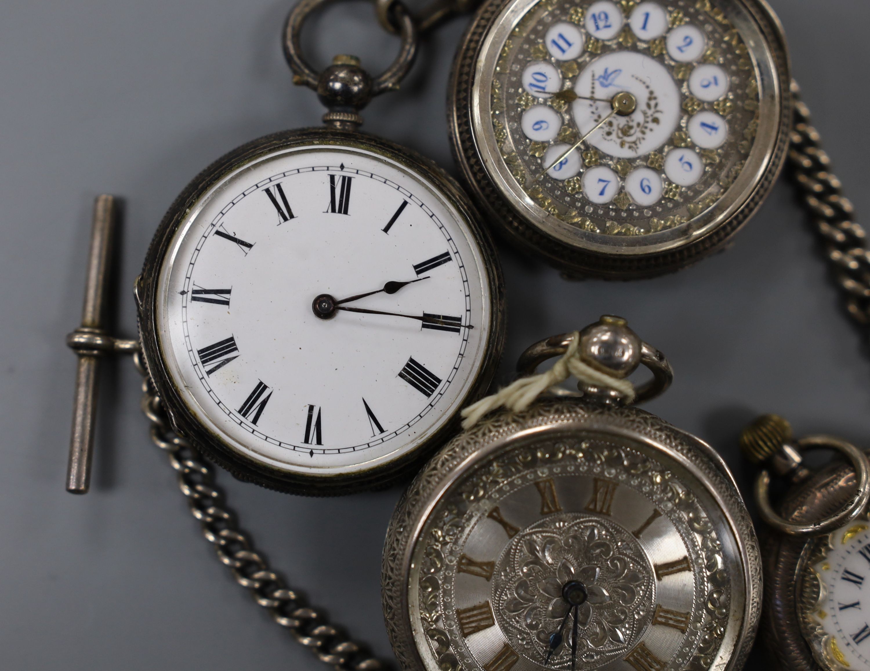 Four assorted late 19th century silver or white metal fob watches including two with case.